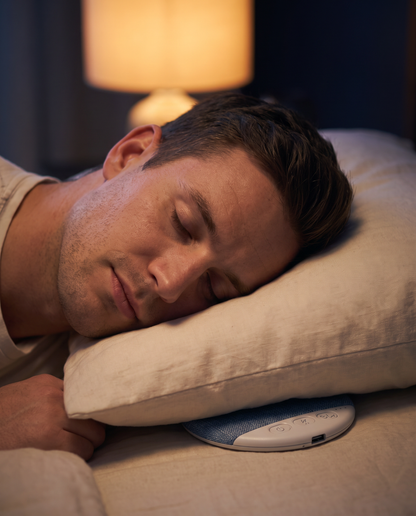 Man sleeping on his side with bare ears and the Undertone speaker tucked under his pillow