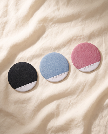 Undertone speakers in black, blue, and blush on cream linen